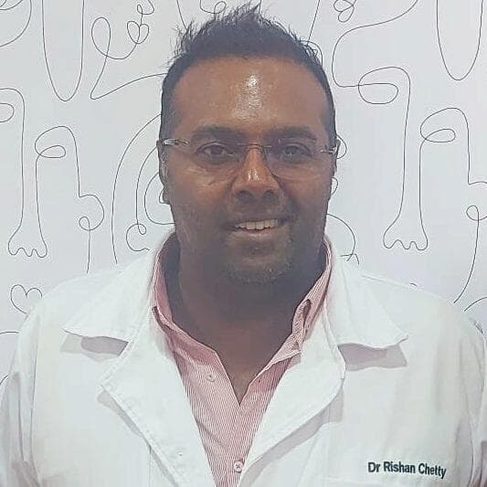 Portrait of Dr R. Chetty in a white clinical coat